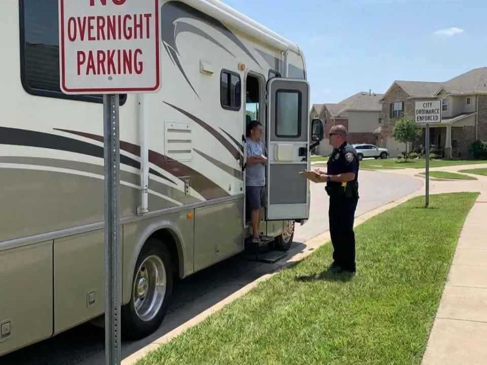 A cop giving citations to an RV owner discussing why is living in an rv illegal