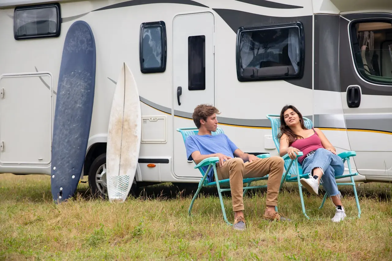 A couple discussing about how much does a rv cost with their RV behind them